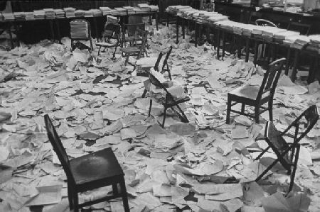 Papers covering the courts transcript room after a war crimes trial in Germany