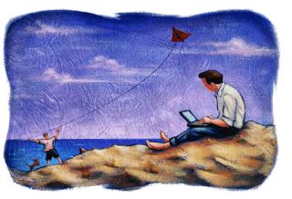 Man on beach watching boy fly kite