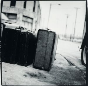 Old suitcases next to a car